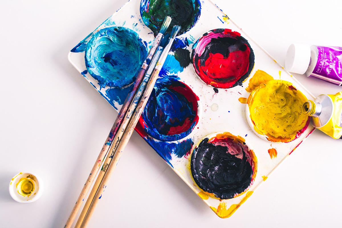 Messy paint palette and brushes